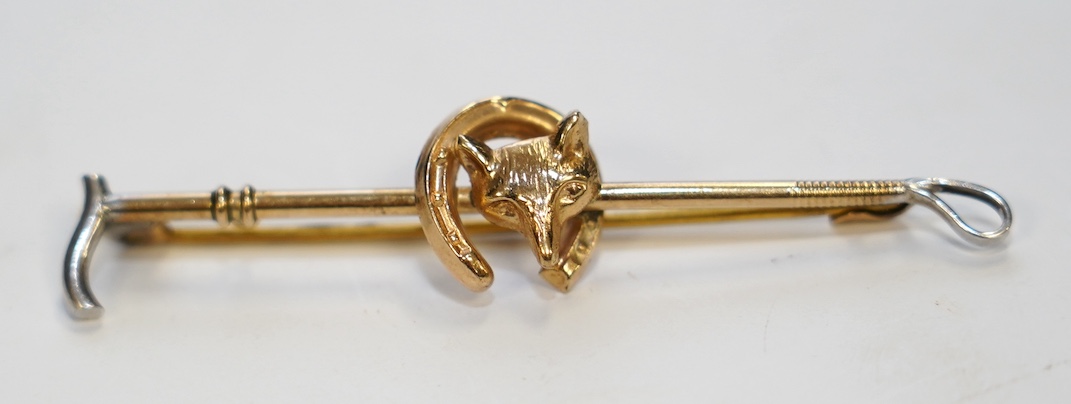 A 9ct and white metal fox head and riding crop tie pin, 56mm, gross weight 2.5 grams. Condition - good